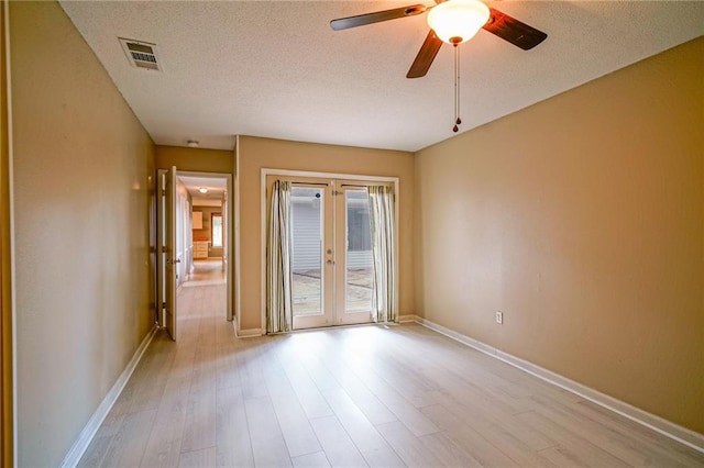 808 N Pearl St, Slidell, LA 70461 - unfurnished room with french doors, wood finished floors, a ceiling fan, and a textured ceiling