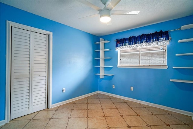 808 N Pearl St, Slidell, LA 70461 - unfurnished bedroom with a closet, a textured ceiling, a ceiling fan, and tile patterned floors