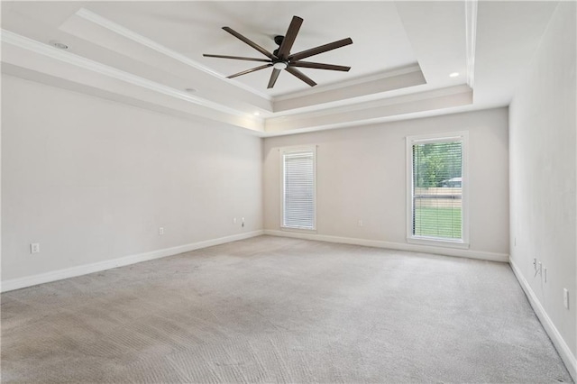 804 S Hawthorn Ct, Slidell, LA 70458 - empty room featuring a tray ceiling, ceiling fan, crown molding, and light colored carpet