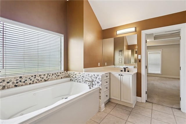804 S Hawthorn Ct, Slidell, LA 70458 - bathroom with vaulted ceiling, vanity, a tub with jets, and tile patterned flooring