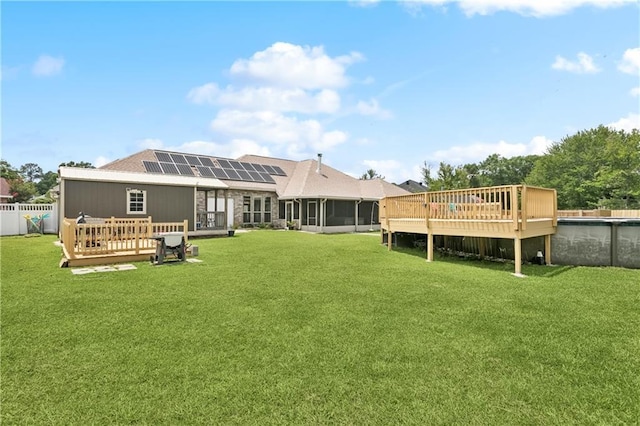 804 S Hawthorn Ct, Slidell, LA 70458 - back of house featuring a sunroom, a wooden deck, solar panels, and an outdoor pool