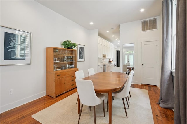 208 S Scott St, New Orleans, LA 70119 - dining room with light wood-style flooring and recessed lighting