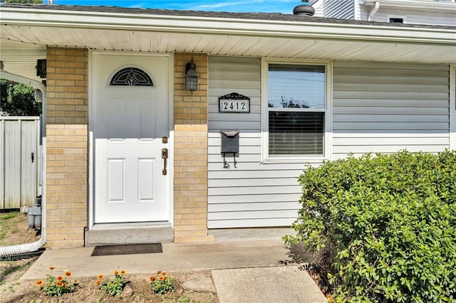 2412 Green Acres Rd, Metairie, LA 70003 - view of exterior entry with brick siding and a porch