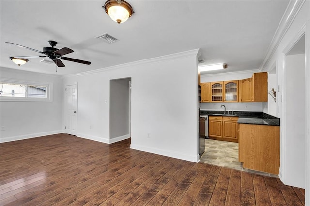 2412 Green Acres Rd, Metairie, LA 70003 - kitchen featuring dark countertops, crown molding, glass insert cabinets, brown cabinets, and hardwood / wood-style floors