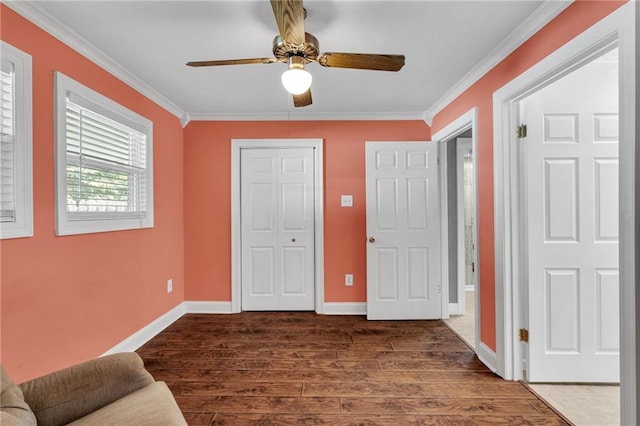 2412 Green Acres Rd, Metairie, LA 70003 - unfurnished bedroom with crown molding, dark wood-style flooring, ceiling fan, and a closet