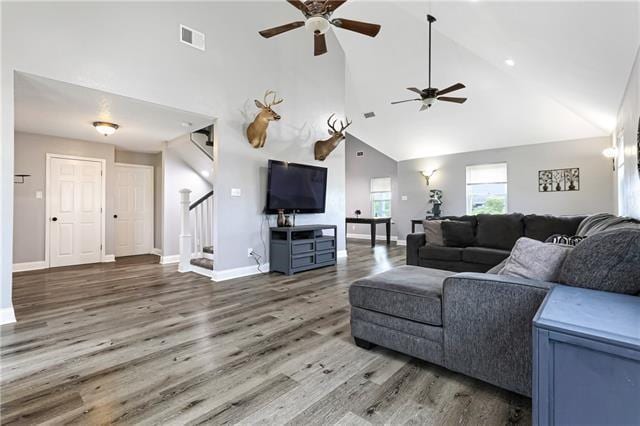 5080 Betty Mae St, Lafitte, LA 70067 - living room with ceiling fan, high vaulted ceiling, stairs, and wood finished floors