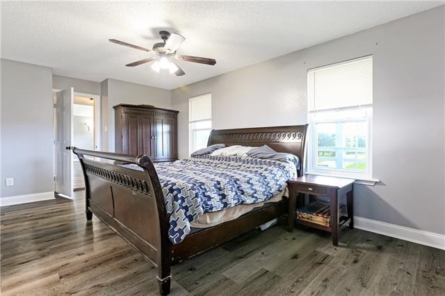 5080 Betty Mae St, Lafitte, LA 70067 - bedroom featuring multiple windows, wood finished floors, and a ceiling fan