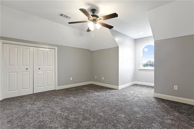 5080 Betty Mae St, Lafitte, LA 70067 - bonus room featuring a ceiling fan, dark carpet, and lofted ceiling