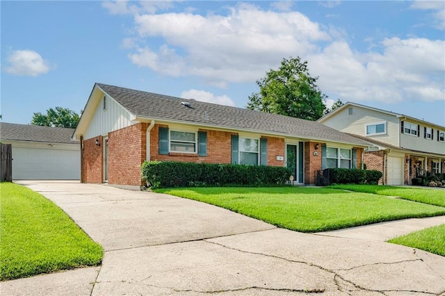 2018 Saint Nick Dr, New Orleans, LA 70131 - view of front facade with brick siding, a front lawn, driveway, roof with shingles, and board and batten siding
