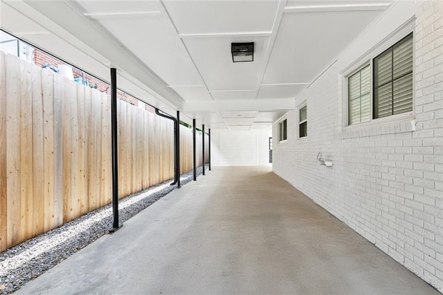 1221 Brockenbraugh Ct, Metairie, LA 70005 - hallway featuring brick wall and concrete floors