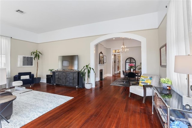401 Pelican Ave, New Orleans, LA 70114 - living room featuring arched walkways, a chandelier, and wood-type flooring