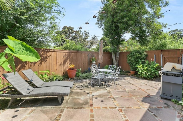401 Pelican Ave, New Orleans, LA 70114 - fenced backyard with grilling area, a patio area, and outdoor dining area