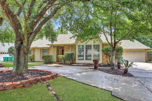 891 Cross Gates Blvd, Slidell, LA 70461 - view of front of house with concrete driveway, a garage, a shingled roof, a front lawn, and brick siding