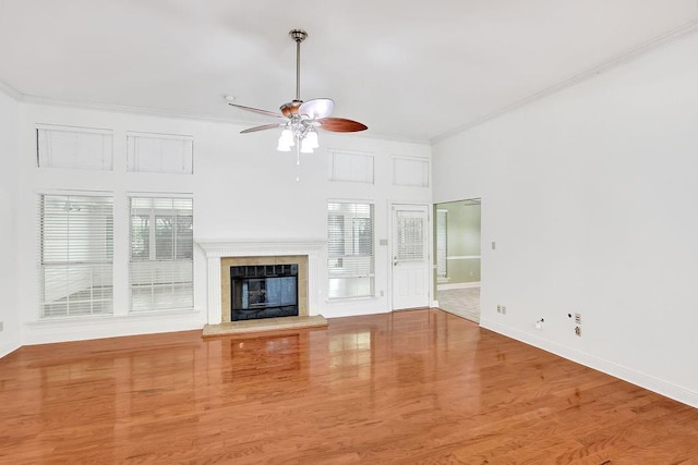 891 Cross Gates Blvd, Slidell, LA 70461 - unfurnished living room featuring a ceiling fan, ornamental molding, a tile fireplace, and wood finished floors