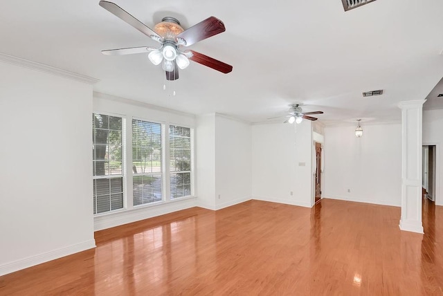 891 Cross Gates Blvd, Slidell, LA 70461 - unfurnished room featuring decorative columns, ceiling fan, wood finished floors, and crown molding