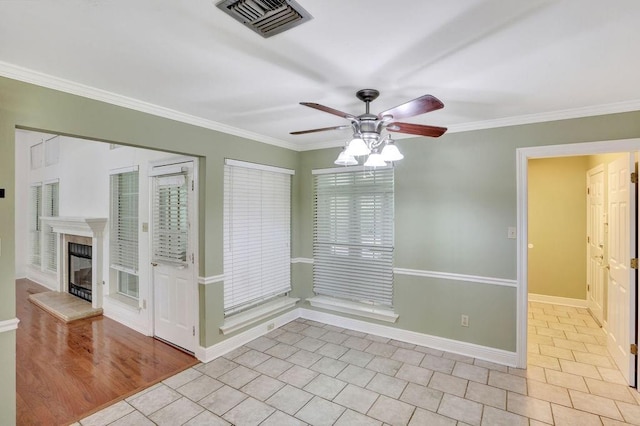 891 Cross Gates Blvd, Slidell, LA 70461 - empty room featuring ceiling fan, light tile patterned floors, crown molding, and a tiled fireplace