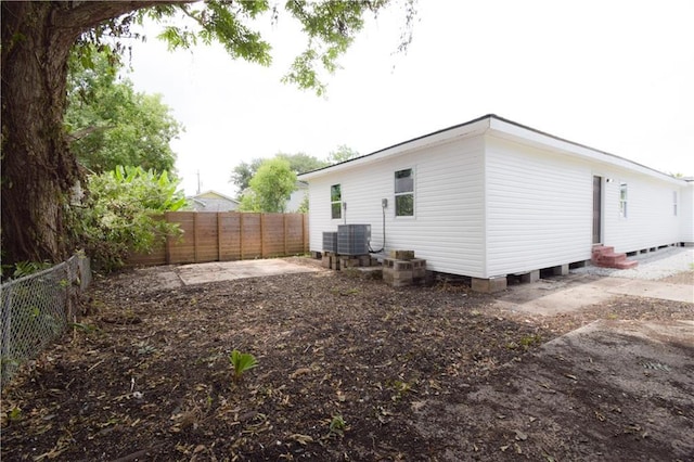 4235 Alfred St, New Orleans, LA 70122 - back of property with entry steps, a fenced backyard, and a patio