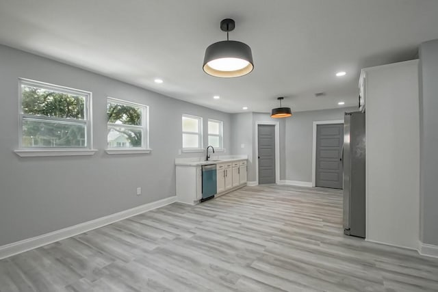 206 Fairfax Pl, New Orleans, LA 70131 - kitchen with dishwashing machine, freestanding refrigerator, recessed lighting, light countertops, and hanging light fixtures