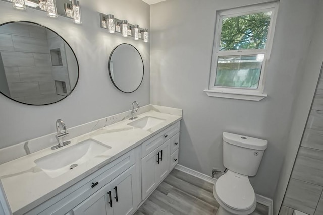 206 Fairfax Pl, New Orleans, LA 70131 - bathroom featuring double vanity and wood finished floors