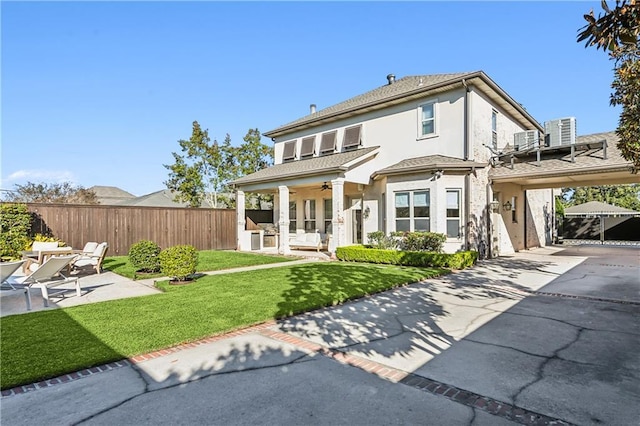 1456 Cherokee Ave, Metairie, LA 70005 - rear view of house featuring driveway, stucco siding, a ceiling fan, a patio area, and a carport