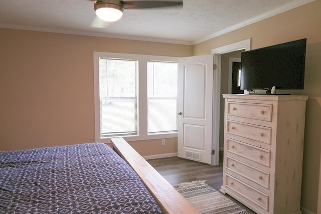480 Woody Rd Unit 0, Jayess, MS 39641 - bedroom with dark wood finished floors, ornamental molding, a textured ceiling, and a ceiling fan