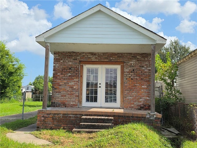 2365 N Tonti St, New Orleans, LA 70117 - view of side of property featuring french doors and brick siding