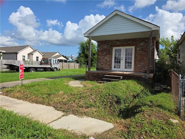 2365 N Tonti St, New Orleans, LA 70117 - view of side of property with french doors and brick siding