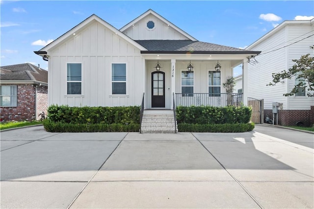 1316 Hickory Ave, Harahan, LA 70123 - view of front of home featuring board and batten siding, covered porch, and a shingled roof