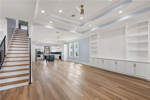 1316 Hickory Ave, Harahan, LA 70123 - unfurnished living room with crown molding, a ceiling fan, recessed lighting, stairs, and a tray ceiling