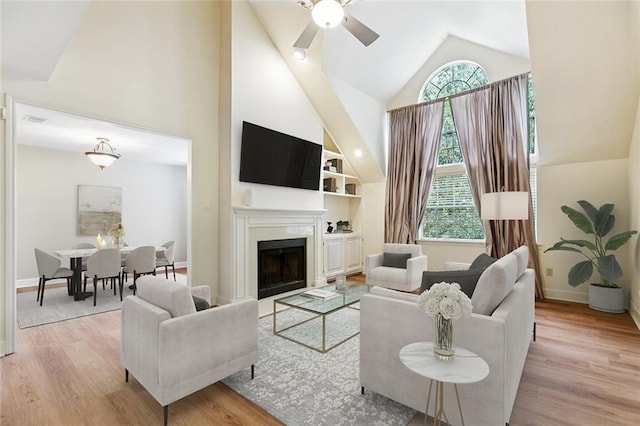 3523 Audubon Trce Unit 3523, Jefferson, LA 70121 - living area with high vaulted ceiling, a ceiling fan, wood finished floors, and a fireplace
