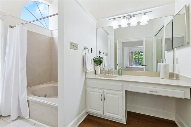 3523 Audubon Trce Unit 3523, Jefferson, LA 70121 - full bath with vanity, wood finished floors, and a combined bath / shower with jetted tub
