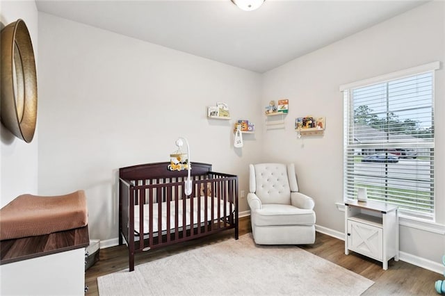 41763 Whisper Woods Rd, Ponchatoula, LA 70454 - bedroom featuring wood finished floors and a nursery area