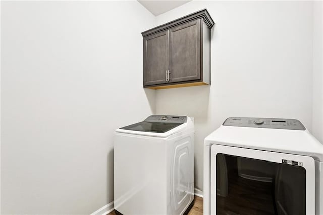 41763 Whisper Woods Rd, Ponchatoula, LA 70454 - laundry room with cabinet space, washer and clothes dryer, and light wood-style floors