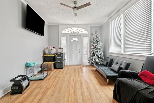 1631 S Salcedo St, New Orleans, LA 70125 - living area with wood finished floors, a ceiling fan, a textured ceiling, and crown molding