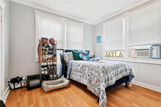 1631 S Salcedo St, New Orleans, LA 70125 - bedroom with ornamental molding, wood finished floors, multiple windows, and cooling unit