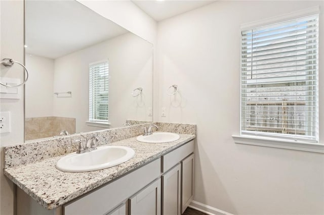 24359 Dawson Ct, Ponchatoula, LA 70454 - bathroom featuring double vanity and baseboards