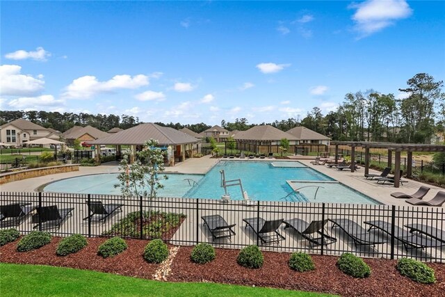 24359 Dawson Ct, Ponchatoula, LA 70454 - community pool featuring a patio and a residential view