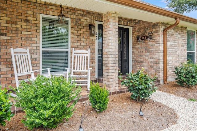 42 Melrose Dr, Destrehan, LA 70047 - view of exterior entry with a porch and brick siding