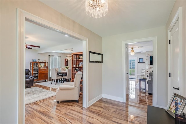 42 Melrose Dr, Destrehan, LA 70047 - corridor featuring a chandelier and light wood-style floors
