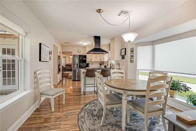 42 Melrose Dr, Destrehan, LA 70047 - dining space featuring light wood finished floors and healthy amount of natural light