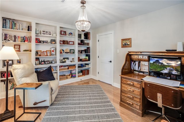 42 Melrose Dr, Destrehan, LA 70047 - home office with a chandelier and light wood-style floors