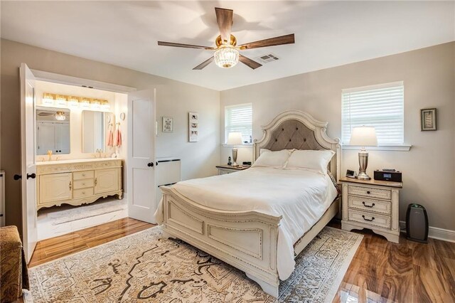 42 Melrose Dr, Destrehan, LA 70047 - bedroom with ensuite bathroom, wood finished floors, and ceiling fan