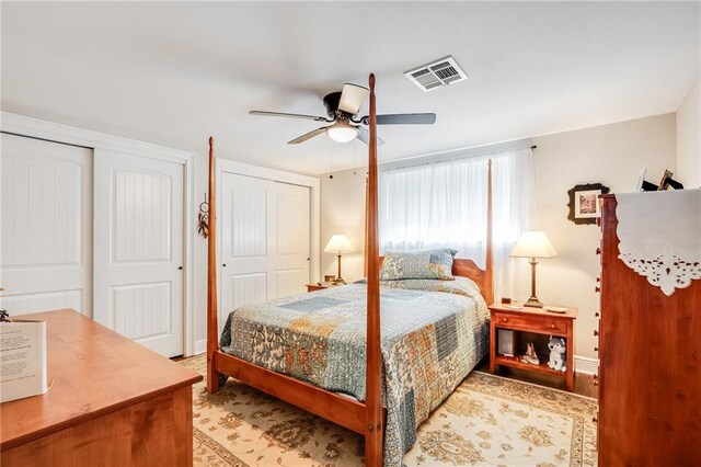 42 Melrose Dr, Destrehan, LA 70047 - bedroom with two closets, ceiling fan, and light wood-style flooring