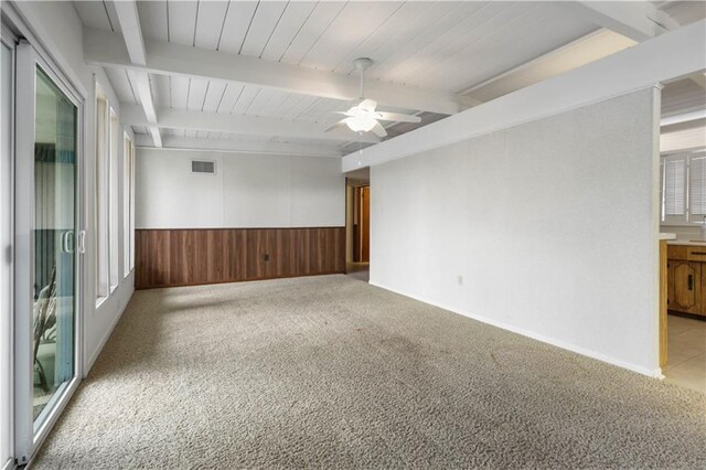 2812 Green Acres Rd, Metairie, LA 70003 - carpeted empty room featuring ceiling fan, wainscoting, wood walls, and beamed ceiling