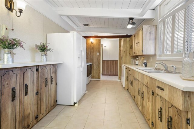 2812 Green Acres Rd, Metairie, LA 70003 - kitchen with white appliances, beamed ceiling, light countertops, light tile patterned flooring, and wooden walls