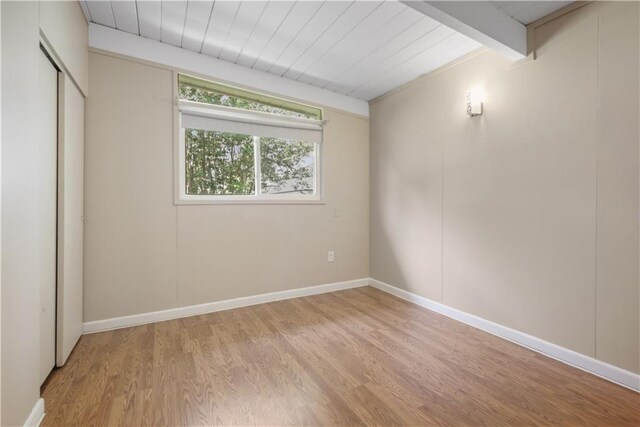 2812 Green Acres Rd, Metairie, LA 70003 - unfurnished bedroom with light wood-style floors, a closet, and beam ceiling