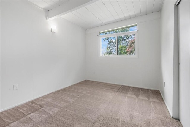 2812 Green Acres Rd, Metairie, LA 70003 - carpeted empty room with a wooden ceiling with exposed beams