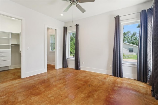 904 W 16th Ave, Covington, LA 70433 - unfurnished bedroom with a walk in closet, finished concrete floors, recessed lighting, and ceiling fan