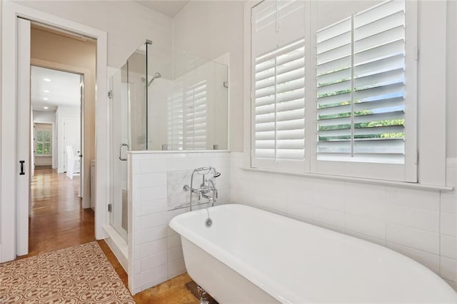 904 W 16th Ave, Covington, LA 70433 - full bath featuring a shower stall, a freestanding tub, wood finished floors, and tile walls