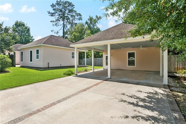 904 W 16th Ave, Covington, LA 70433 - back of house featuring ceiling fan, concrete driveway, a shingled roof, and a carport